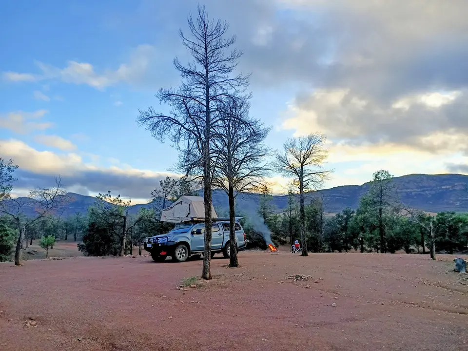 AMP'D 12V D-Max set up with a rooftop tent and campfire in the Australian bush